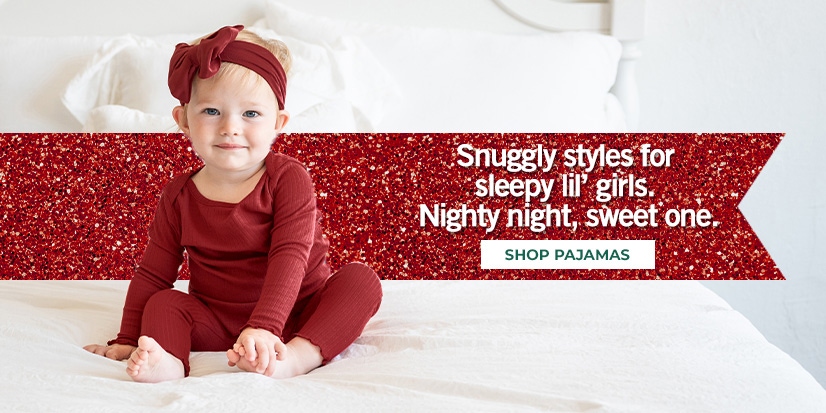 Snuggle styles for sleepy lil girls. Nighty night, sweet one. A seated girl wearing pajamas.
